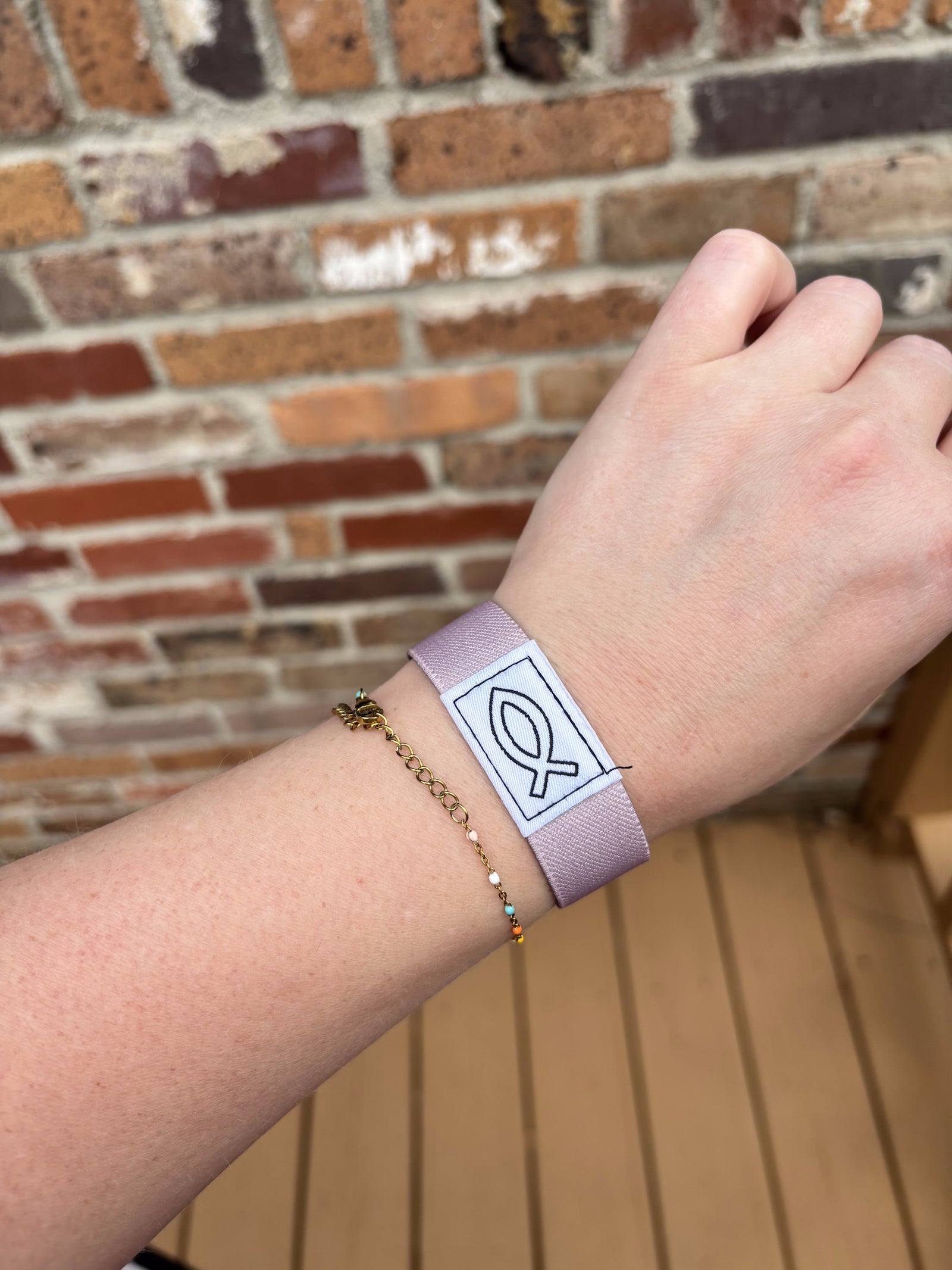 The Bible Band Christian NFC wristband in Mauve worn on a wrist
