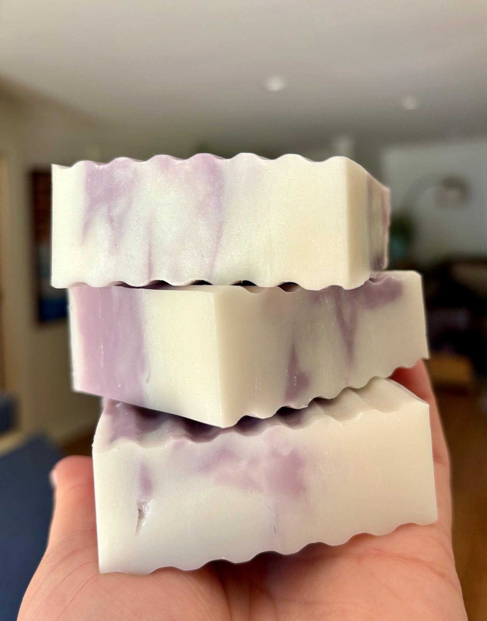 Stack of purple and white Wildcat Swirl soap bars
